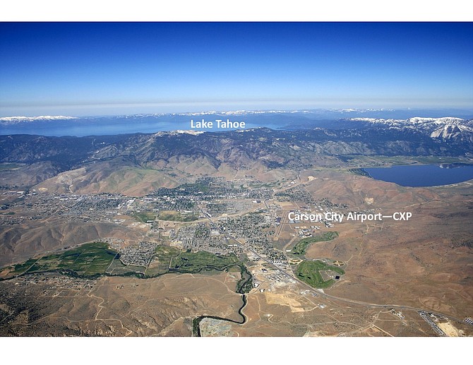 An aerial view showing the Carson City Airport on the north end of the city and Lake Tahoe in the background.