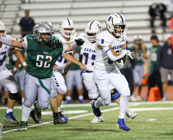 Carson High's Johnathan Alvarado escapes for a touchdown run against Hug last week. Friday night, Avarado and the Senators beat Wooster, 40-0.