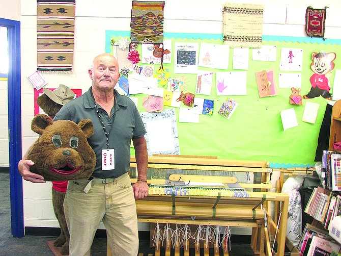 Zephyr Cove Elementary School volunteer Greg Kinner, also known as Cubby stands with one of the looms in his classroom.