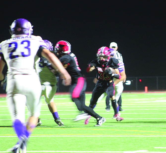 Josiah Hunt (33) runs the ball for the Mustangs at Friday’s homecoming game.