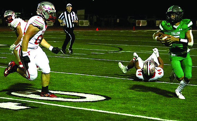 Truckee linebacker Miles Macusko (64) heads toward Fallon quarterback Matthew Bird in the second half in Friday’s home football game against Truckee.