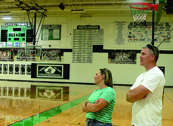 Former Greenwave basketball player Jeff Peterson, right, and his wife Nettie (Sorensen) look at the banner and state championships in the Churchill County High School gym. Peterson returned to Fallon last weekend to be inducted into the 2024 Greenwave Hall of Fame class.