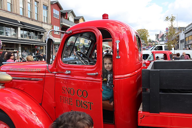 A child looks out from the door of a pickup truck bearing Getchell Fire (Fire District 22)'s name during the annual Snohomish Classic Car and Hot Rod Display Sunday, Sept. 29, 2024 put on by the Snohomish Chamber of Commerce.