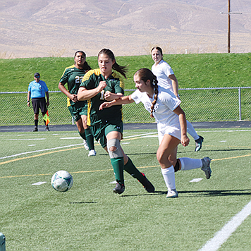 Battle Mountain’s Alivia Leibhardt fights for control of the ball against White Pine on Saturday.