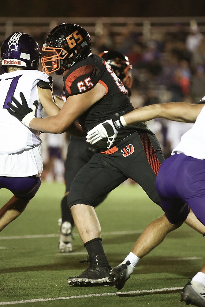 Douglas High junior Peio Ithurburu blocks last Friday. Ithurburu and the Tigers travel to McQueen this Friday.