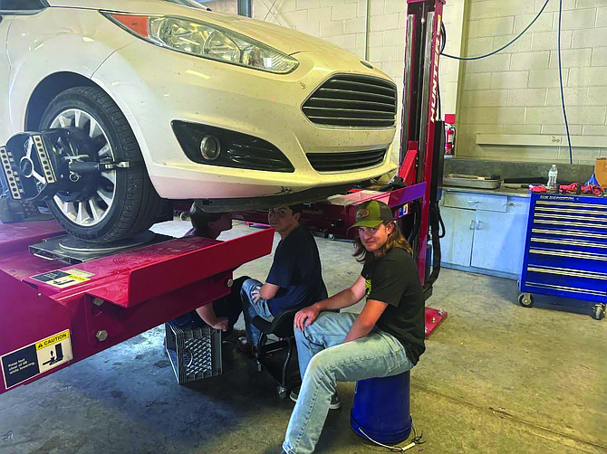 Auto Shop students working on a staff member's vehicle.