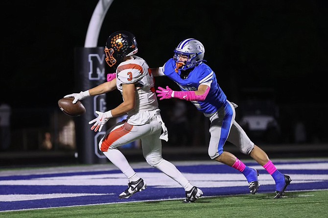 Douglas High’s Nathan Priou (3) reaches out across the goal line for a touchdown, during the Tigers’ 49-21 win over the Lancers Friday night.