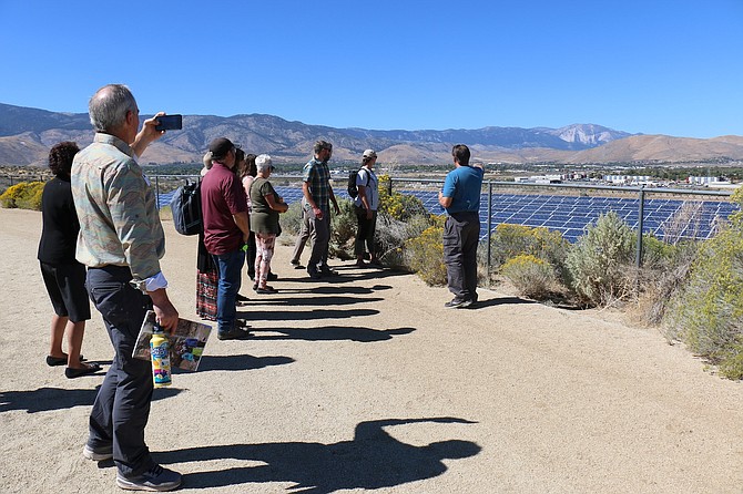 Mark Korinek, GSSN strategy coach and former director of operations for the Carson City School District, right, takes a group of Carson and Reno educators on a tour up to Eagle Valley Middle School’s track to view an array of solar panels installed by Reno’s Hamilton Solar.