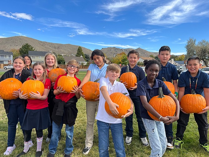 Seeliger Elementary students help sort pumpkins before the 2023 Pumpkin Patch.