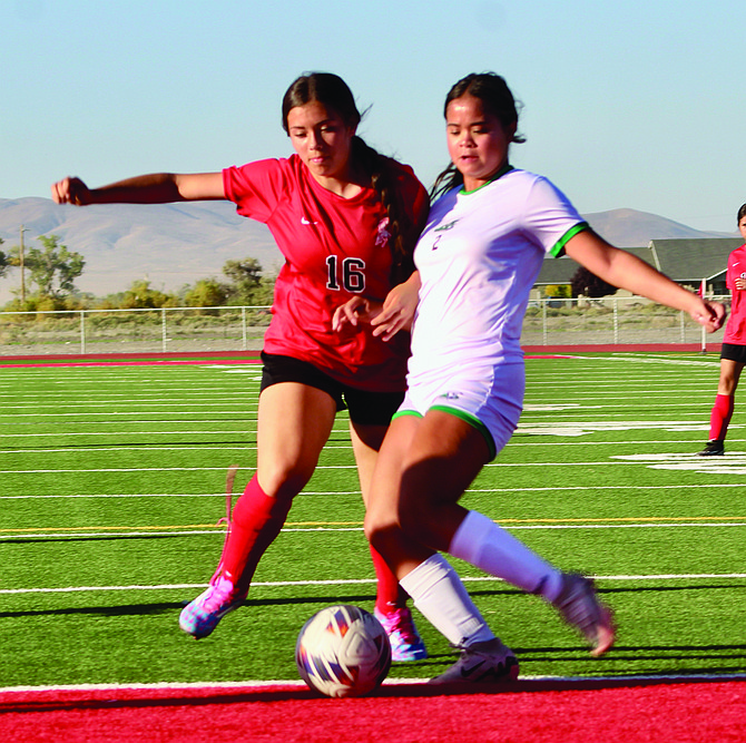 Pershing freshman Desaray Vidrio (16) challenges Fallon for possession of the ball last Tuesday at PCHS.