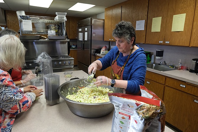 Nancy Lombard prepares food at the Community Kitchen at St. John’s Episcopal Church in Snohomish. Volunteers from churches and the Kiwanis prepare meals for those in need on Mondays and Thursdays.