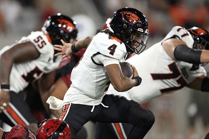 Oregon State quarterback Gevani McCoy (4) scrambles out of the pocket against San Diego State earlier this season. McCoy played at Mackay Stadium last year, when he led Idaho to a big win over Nevada.