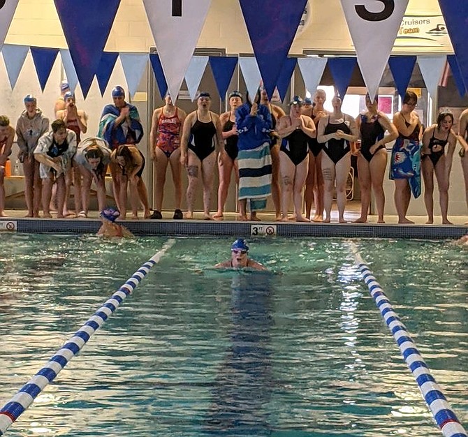 Eatonville’s Annika Howard pulls ahead of the competition in the breaststroke portion of the 200 IM, as she goes on to win the event as her fellow Cruisers teammates cheer her on from the end of her lane.