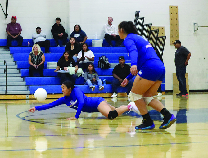 McDermitt’s Vina Tom dives to the floor for a dig during Saturday’s home match with Eureka.