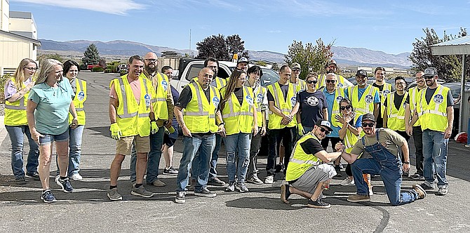 North Sails’ Building 1 Staff celebrate a job well done during their annual cleaning day on Oct. 9 along Haybourne Road.