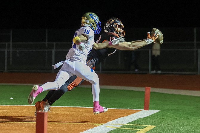 Brenton Weston lunges in an attempt to make a catch in the end zone, during Douglas football's 35-16 loss to Reed Friday night.