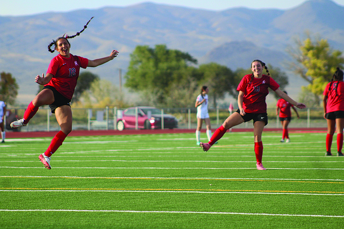 Anika Happy and Kimi Trowbridge celebrate a goal against the Quincy Trojans last Friday at PCHS.