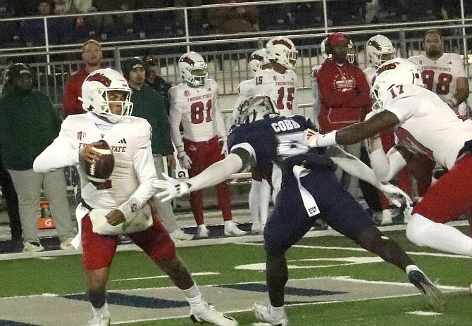 Nevada’s Keyshawn Cobb (5) puts pressure on Fresno State quarterback Mikey Keene in the first half of Friday night’s game at Mackay Stadium.