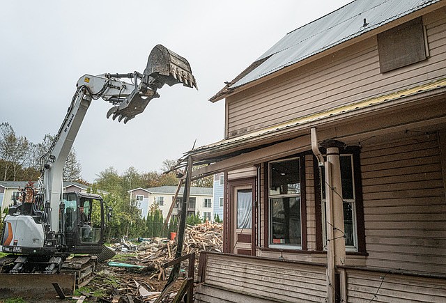 A Bobcat with a claw attacks one of the historic Buck Houses on S. Ann Street demolished on Monday, Oct. 21, 2024.