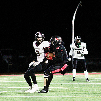 Pershing County's Michael Reitz intercepts a West Wendover pass during the Mustangs' 52-6 win over the Wolverines on Friday night in Lovelock.