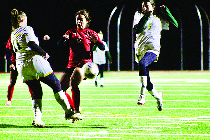 Lexie Portillo (8) confronts a Battle Mountain player on senior night at PCHS.