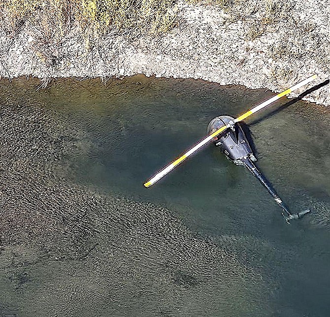 A helicopter is submerged in the East Fork of the Carson River after the pilot was rescued. Alpine County photo