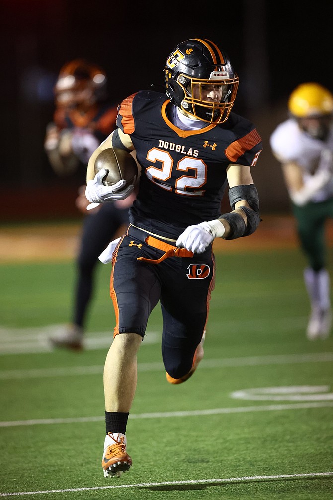 Douglas High’s Zack Jackson gets into the open field Thursday night against Bishop Manogue. Jackson returned a kickoff 99 yards for a touchdown in the Tigers’ 48-24 loss to Bishop Manogue.