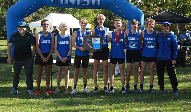 The Carson High School boys cross country team poses at the finish line with the Class 5A North regional cross country title. Pictured from left to right are, coach Jason Macy, Nate Freed, Quinn Kuchnicki, Sawyer Macy, Alex Miner, Sean Thornton. Seth Chalmers, Ivan Romeo and coach Jon Hager.