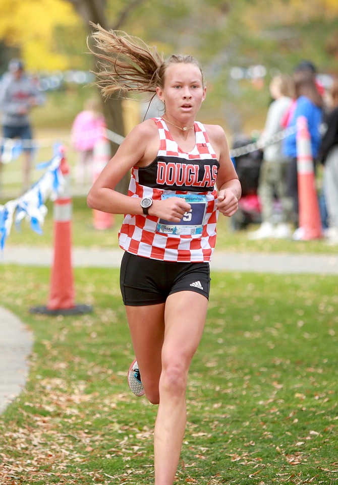 Douglas High’s Lucy Nord runs a downhill portion of the Class 5A North regional cross country course Friday. Nord finished fifth as an individual while the Tigers were third as a team, punching their ticket to state as a group.