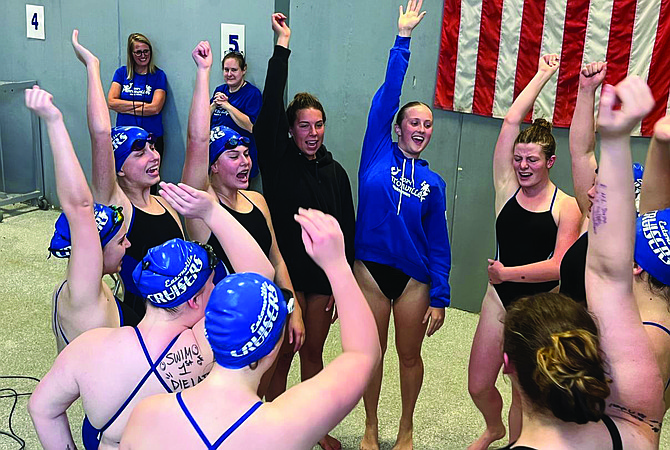 The Eatonville swim team gets themselves pumped up before the meet with a pre meet cheer.