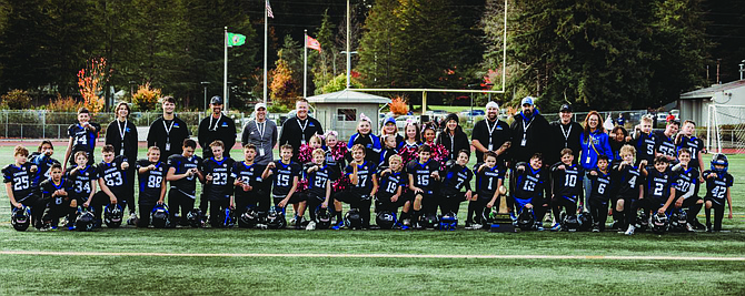 The Eatonville Jr. Cruisers MV team, coaches and support staff pose for a photo following their 22-14 victory over Yelm.