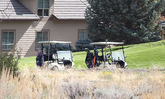 Golf carts await the ride to the next hole at Genoa Lakes on Saturday.