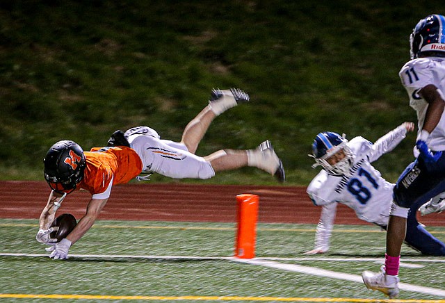 Monroe Bearcat senior Mason Davis flies for the goal line, capping a long run for his first of three touchdowns against Meadowdale on Friday, Oct. 25. The Bearcats scored on the ground and in the air to garner 56- 9,  their fourth straight League title and to move on into the playoff season. Monroe led 28 - 3 in the sloppily played, penalty-filled first half.  
Monroe is dominating 3A South with a season record of 7-1 overall, 6-0 league. 
The Bearcats host Oak Harbor at home this Friday night.