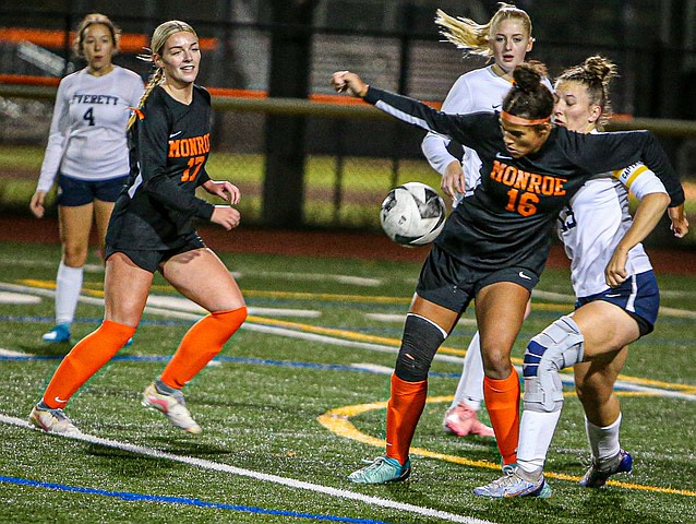 Bearcat sophomore Addison Williams (No. 16) forcefully blocks Everett Seagull Captain, senior Sienna Kuelin before smashing the ball out of the Bearcat goal area during their match Tuesday, Oct. 21 in Monroe.  The Bearcats clawed a win 2 - 1 over the Everett Seagulls. Monroe charged in the first half as Senior Sydney Garner found the net in the 11th minute.  Seagulls sophomore Regina Foy tied the match in the second half. Bearcats Junior Paige Underwood capped the scoring and the win in the 77th minute of play.