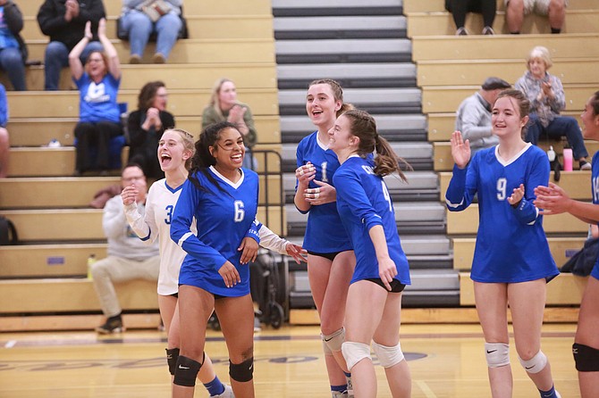 The Carson High School volleyball team celebrates after knocking off Spanish Springs in the opening round of the Class 5A North regional playoffs Monday at Spanish Springs High School. Pictured from left to right are Ava Kordonowy (3), Clarissa Quintana (6), Abby Franco (1), Emma Sanders (4) and Hannah Gerow (9).