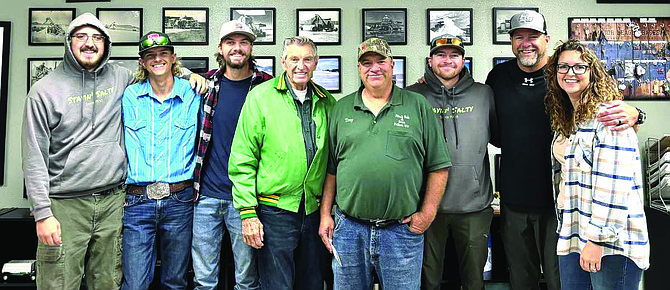 The Huckaby family on Oct. 17 stands in front of the Huck Salt memory wall. From left: Conner Holcombe, Tanner Huckaby, Kandon Huckaby, John Huckaby, Troy Huckaby, Kovey Huckaby, Tron Huckaby and Jessica Huckaby.