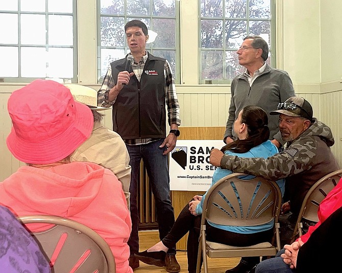 Republican Senate candidate Sam Brown, center, talks to Fallon residents on Wednesday. U.S. Sen. John Barrasso, right, accompanied Brown and urged local Republicans to support the Army veteran.