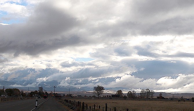 Clouds cling to the Pine Nut Mountains on Tuesday morning.