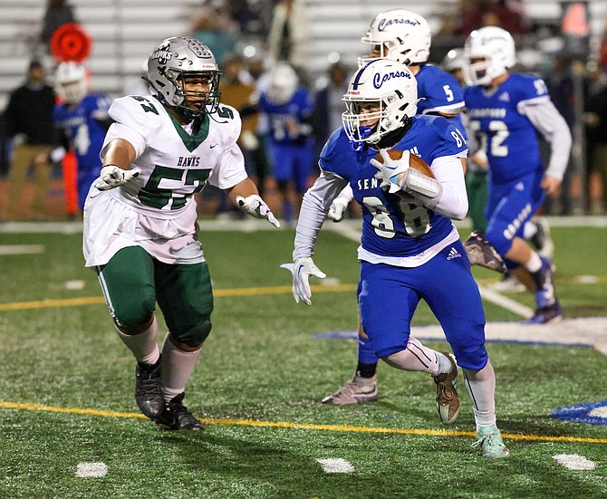 Carson’s Brayden Welch returns a pick six late in fourth quarter, during the Senators’ 58-0 win over Hug in the opening round of the Class 5A North Div. III regional playoffs.