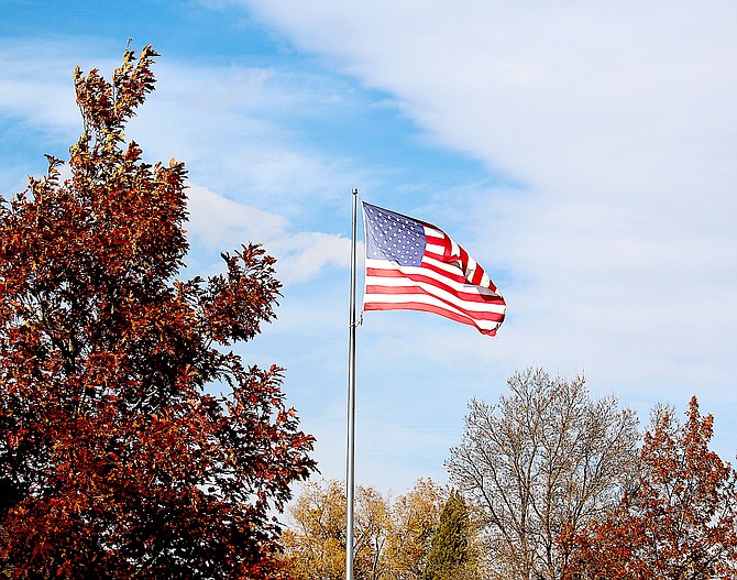 The wind lofted the flag over Minden Park on Friday afternoon as a storm front pushed into the Sierra.