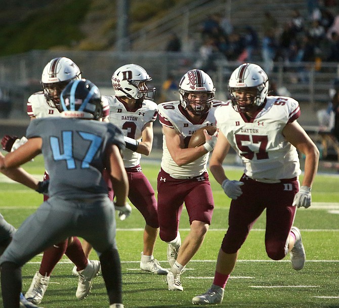 Dayton sophomore running back Duke Evans (10) follows his blocking on the way to a touchdown against Coral Academy last Saturday. Evans has 1,525 rushing yards this season and 17 rushing touchdowns.