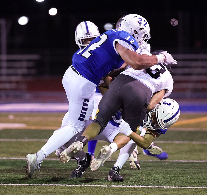 Carson High’s Justin Gonzalez (32) and Aaron Witt (3) combine to make a tackle in a game earlier this season. Gonzalez is second on the team in total tackles with 92 in his first year on the varsity roster.