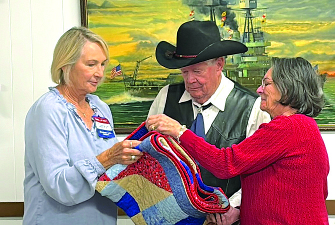 Veteran Jim “Deacon” Pellham receives his Quilt of Valor from the Comstock Lode Quilters during an Oct. 19 awarding ceremony.