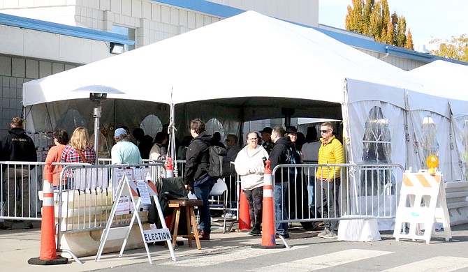 Voters wait in line Tuesday at the Carson City Community Center to cast their votes at lunchtime.