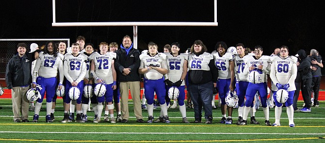 Members of Eatonville's offensive and defensive line group pose with line coaches Wes Potter and Memphis Barney following the team's season ending loss to Orting. The line is what does the dirty work in the trenches that allows for the team's offensive explosion and defensive stops. From L to R: Coach Barney, Hebron Leasiolagi (67), Brett Hutchings (74 - back row), Sam Reece (63), Nate Smith (76 - back row), Jose Cruz Diaz (52 - back row), Anthony McChesney-Berube (72), Zach Beane Perdue (75 - back row), Coach Potter, Aaron Tozer (73), Nicholas Shipman (55), Christian Clay (66), Isiah Whatley (56), Ellis Sarpy (78), Ethan Rogers (64), and Anthony Thorlacius. Not pictured -  Asher Bamford.