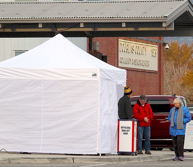 Poll workers 7 a.m. Tuesday at the entrance to the Douglas County Community & Senior Center just as the polls opened. They said the line inside was light.