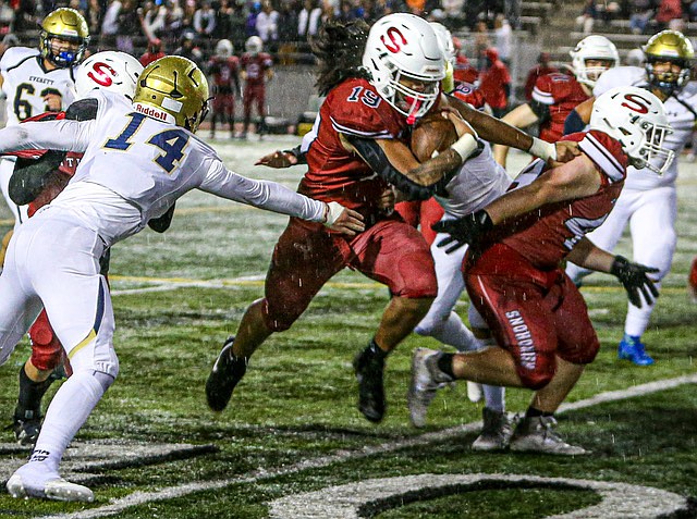 Breaking tackles and following his blockers, Snohomish Panther running back sophomore Ty Tautolo makes yards in the rain-filled first period of the Panthers’ win over Everett 40 - 0 on Friday, Nov. 1 in Snohomish. Snohomish led the scoring with a massive 40 yard field goal and a six-pointer following a blocked extra point attempt.  The Panthers had one score called back but led 23 - 0 at the half, extending their lead further in the game’s last two quarters.
Both teams were expected to not advance to Districts. Snohomish (1-5 league [Wesco 3A North], 2-7 overall) will cap off its season with a home game against Meadowdale. this Friday. Everett (1-5 league [Wesco 3A South], 1-8 overall) will face the Lynnwood Royals this week to finish their season.
Friday night around the area: 
Lake Stevens had a 28-14 upset loss to Arlington which snatched away the Wesco 4A title. Monroe scooted by 1 point to prevail over Oak Harbor in a high scoring game; score was 49-48. Glacier Peak won 28-14 over Kamiak.