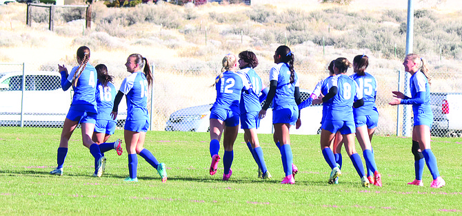 The Lowry High School girls soccer team celebrates after scoring a goal in the quarterfinal match against North Valleys on Tuesday, Oct. 29, in Winnemucca.