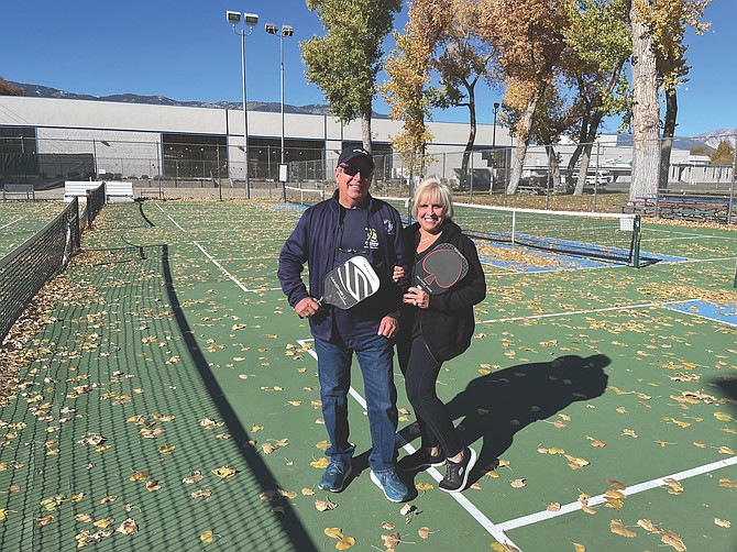 Carson residents and USA Pickleball Ambassadors Dave Whitefield, left, and Juan Beguelin at the pickleball courts they organized to create in Mills Park on Thursday. After gusty winds, they said they would be cleaning the courts of fall leaves this weekend.