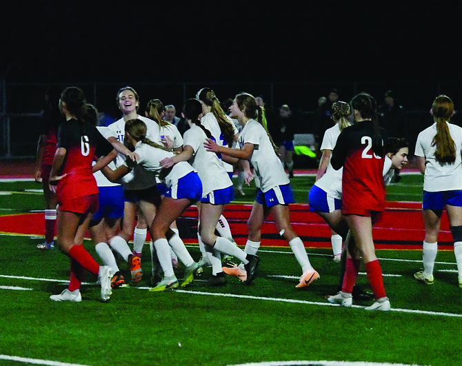 The Eatonville Lady Cruiser soccer team celebrates after defeating their rivals, the Orting Cardinals, 1-0.